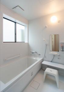 a white bathroom with a tub and a toilet at WABI - Vacation STAY 52963v in Kanazawa +9 photos