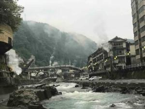 a river in the middle of a city with buildings at Family House "2F" - Vacation STAY 12940 in Kumamoto