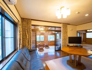 a living room with a couch and a television at MOCHA House - Vacation STAY 12999 in Nasu-yumoto