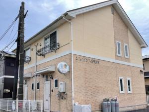 a building with a clock on the side of it at Elegance Kukou Minami B - Vacation STAY 12934 in Miyazaki
