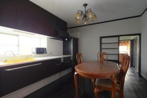 a kitchen with a table and chairs and a sink at Higashichichibu-mura Kominka - Vacation STAY 59627v in Minano