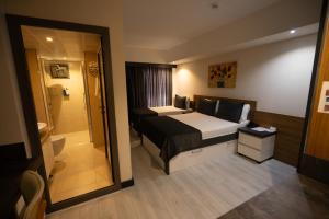 a hotel room with a bed and a bathroom at Devin Otel in Isparta +51 photos