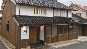 a building with a sign in front of it at MACHIYA HOTEL madoka - Vacation STAY 65847v in Izumo