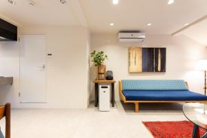 a room with a blue bed and a table at MACHIYA HOTEL madoka - Vacation STAY 65847v in Izumo