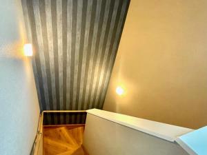 a small room with a curtain and a stair case at BEACH HOUSE Kamogawa - Vacation STAY 64005v in Kamogawa