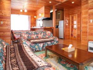 a living room with a couch and a coffee table at Runesu Karuizawa - Vacation STAY 92239v in Tsumagoi
