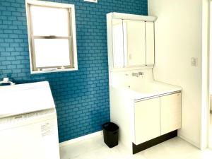 a bathroom with a white sink and blue tiles at BEACH HOUSE Kamogawa - Vacation STAY 64005v in Kamogawa +26 photos