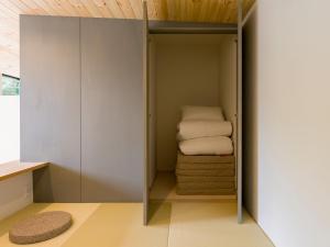 a walk in closet with towels in it at Rakuten STAY VILLA Aso Kurokawa -102 1LDK Capacity of 6 persons in Minamioguni +74 photos