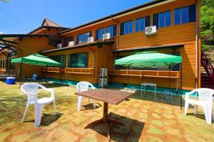 a table and chairs and umbrellas in front of a building at TABIHAKU STAY Kasumi - Vacation STAY 70463v in Kami