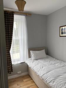 a bed in a room with a window at Castleroddy House in Lislap
