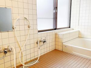 a bathroom with a shower and a bath tub at Runesu Karuizawa - Vacation STAY 78403v in Tsumagoi