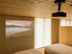 a bedroom with a large window with a view of the lighthouse at Rakuten STAY VILLA Aso Kurokawa -105 1LDK pet allowed Capacity of 6 persons in Minamioguni
