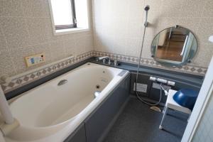 a bath tub in a bathroom with a mirror at Chizu - Vacation STAY 83941v in Mitoyo