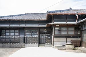 a japanese building with a black roof at Chizu - Vacation STAY 83941v in Mitoyo +2 photos