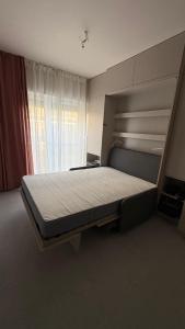 a bedroom with a large bed in front of a window at Sandy Apartment Dzwinów 3 Sand and Dunes Sauna Grota Solna Siłownia in Dziwnów