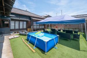 a pool table with a blue umbrella on a lawn at Chizu - Vacation STAY 83974v in Mitoyo