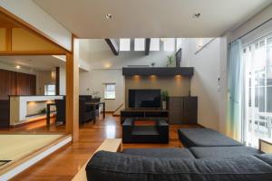 a living room with a couch and a tv at villa-rizo - Vacation STAY 13184 in Hida