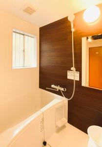 a bathroom with a bath tub and a sink at Mori no yadori Nasu bettei Maruyama - Vacation STAY 13190 in Nasu-yumoto