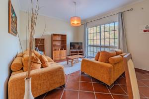 a living room with a couch and two chairs at Simões Charm By HR Madeira in Vila Baleira