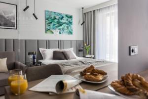 a room with a bed and a table with food on it at Modern View of Planty Park in Kraków +29 photos