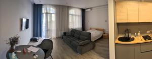 a living room with a couch and a table at Апартаменти біля парку з бюветом мінеральної води in Truskavets +10 photos