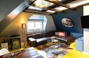 a living room with a couch and a table at Design Apartments Haus Noge in Westerland (Sylt)