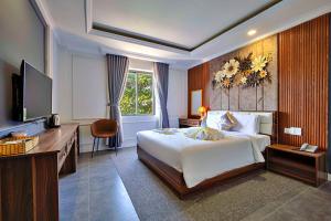 a hotel room with a bed and a television at S79 Happy 88 Tran Hung Dao Street in Phu Quoc