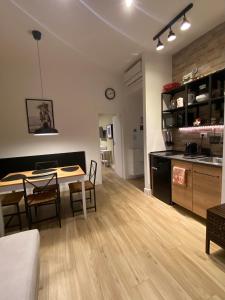 a kitchen and dining room with a table and chairs at Dimora del Papa apartments in Rome