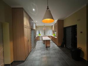 a kitchen with a table in the middle of a hallway at The Cozy Nook in Blantyre
