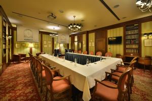 a long table in a room with chairs at Marrol's Boutique Hotel in Bratislava