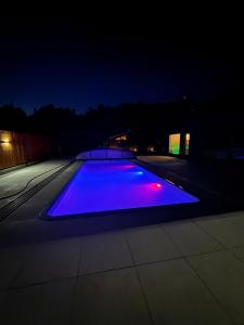 a lit up pool on a roof at night at Osada na Jaworowej in Radawa
