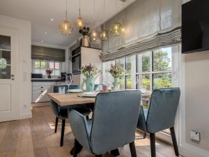 eine Küche und ein Esszimmer mit Tisch und Stühlen in der Unterkunft Südwind's Greta & Sylt in Sylt