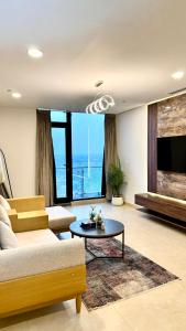 a living room with a couch and a table at Central City View 1BR at Mall Of Islamabad in Islamabad