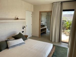 1 dormitorio con cama y vistas a un baño en Villa Victoria El Roque, en Roque 24 fotos más