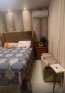 a small bedroom with a bed and a table at Refúgio Devant - COP 30 in Belém +13 photos