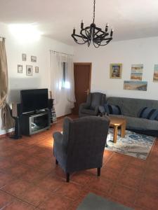 a living room with a couch and a tv at Casa Ramona in Valencia
