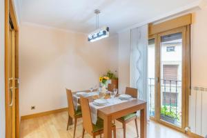 a dining room with a table and chairs and a window at Acogedor apartamento rodeado de naturaleza in Lerate +33 photos