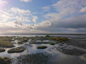 an aerial view of the ocean with rocks and water at 7 person holiday home in Fanø-By Traum in Fanø +36 photos