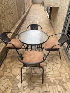a table and two chairs sitting next to a table and chairs at OSIF Chic City Retreat in Yaoundé