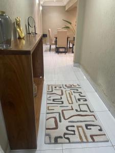 a hallway with a rug on the floor in a room at OSIF Chic City Retreat in Yaoundé