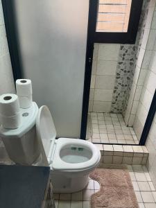 a bathroom with a toilet with two rolls of toilet paper at OSIF Chic City Retreat in Yaoundé +4 photos