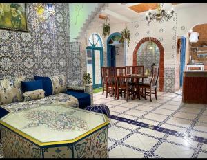 a living room with a couch and a table at riad la citadelle in El Jadida