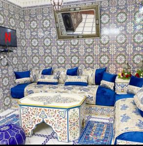 a room with a couch and a table in it at riad la citadelle in El Jadida