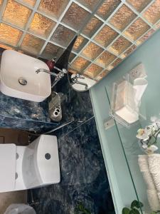 a bathroom with a white toilet in a room at The splendor of the Summer resort in Quai