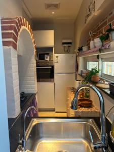 a kitchen with a sink and a refrigerator at The splendor of the Summer resort in Quai +2 photos