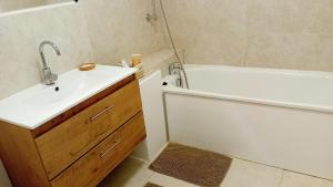 a bathroom with a sink and a tub and a toilet at La Collégiale in LʼIsle-sur-la-Sorgue