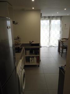 a kitchen with a sink and a stove top oven at Appartement 1 chambre in Jayat