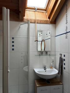 a bathroom with a sink and a shower at Ferienwohnung Barbara in Oberammergau +32 photos