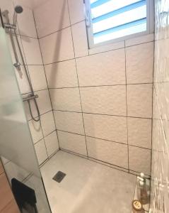 a bathroom with a shower with a window at KaZandoli in Les Anses-dʼArlets +49 photos