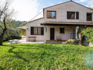 a white house with a grassy yard at Charming Flat with Pool in Drap